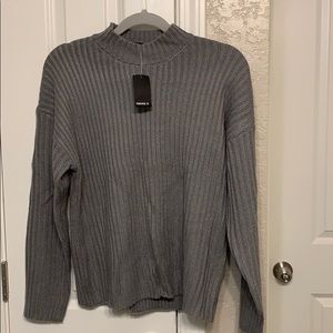 Grey sweater with mock neck.
